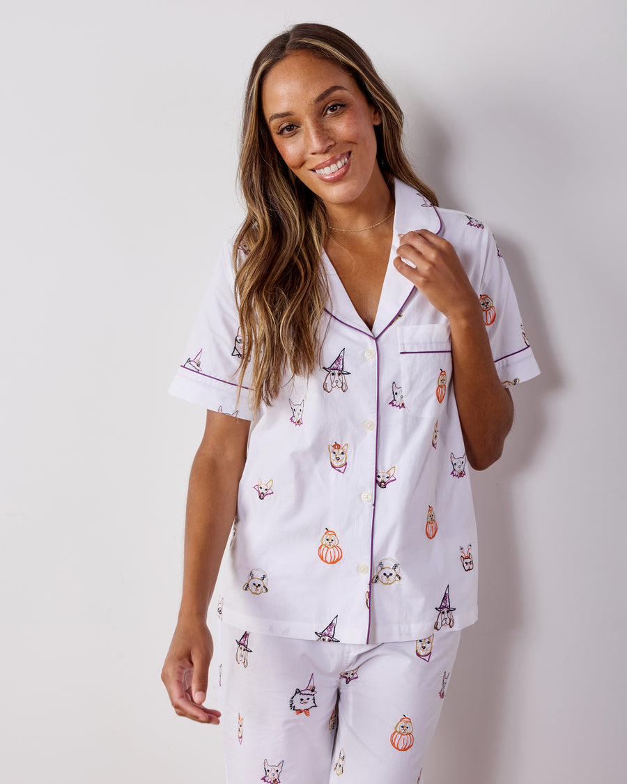 Person modeling the Halloween Hounds short-sleeve button-down top and cropped pants set, showing the front and dog costume print.
