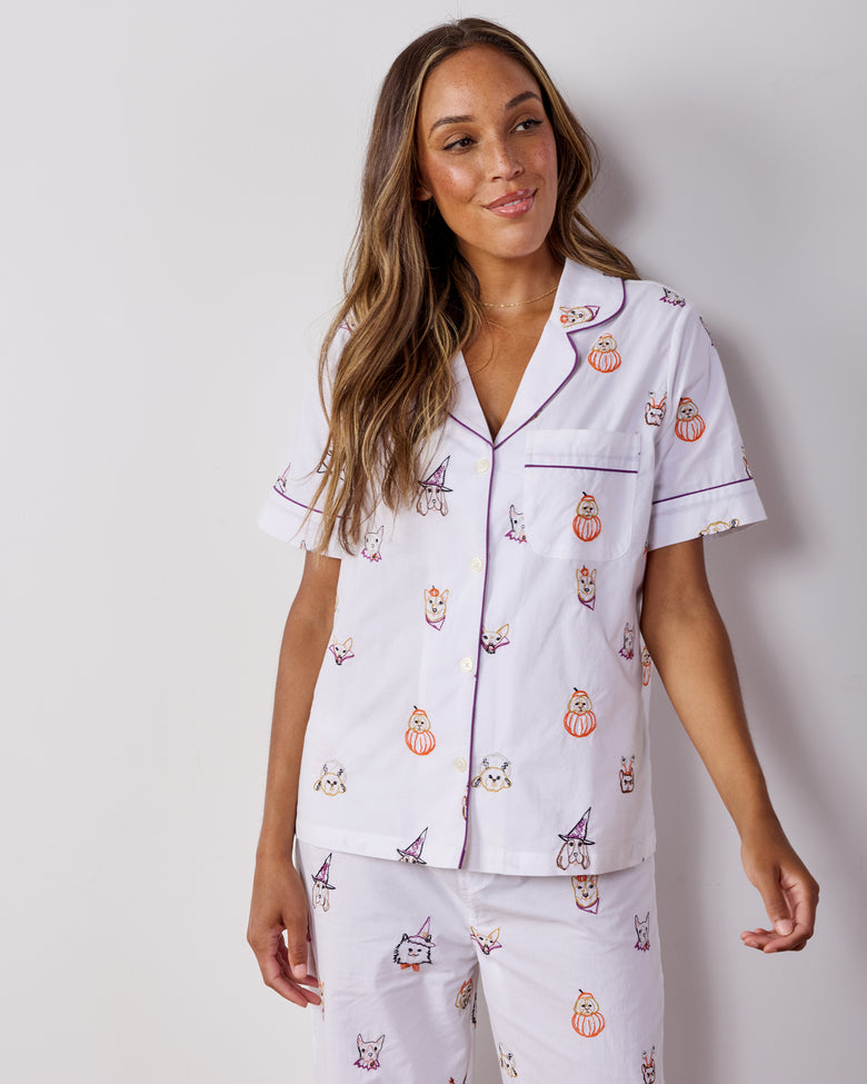 Person modeling the Halloween Hounds short-sleeve pajama set from a three-quarter front view, showing the dog costume print.