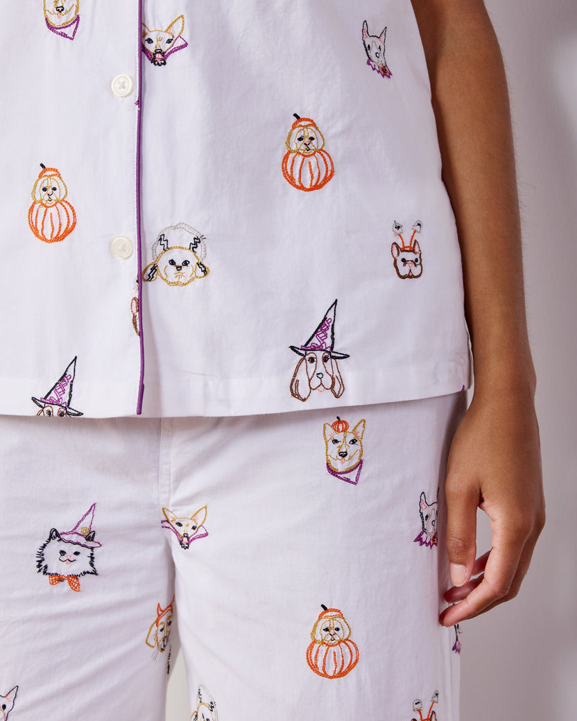 Close-up of the Halloween Hounds pajama top and cropped pants showing dog costume motifs, buttons, piping, and cropped hems.