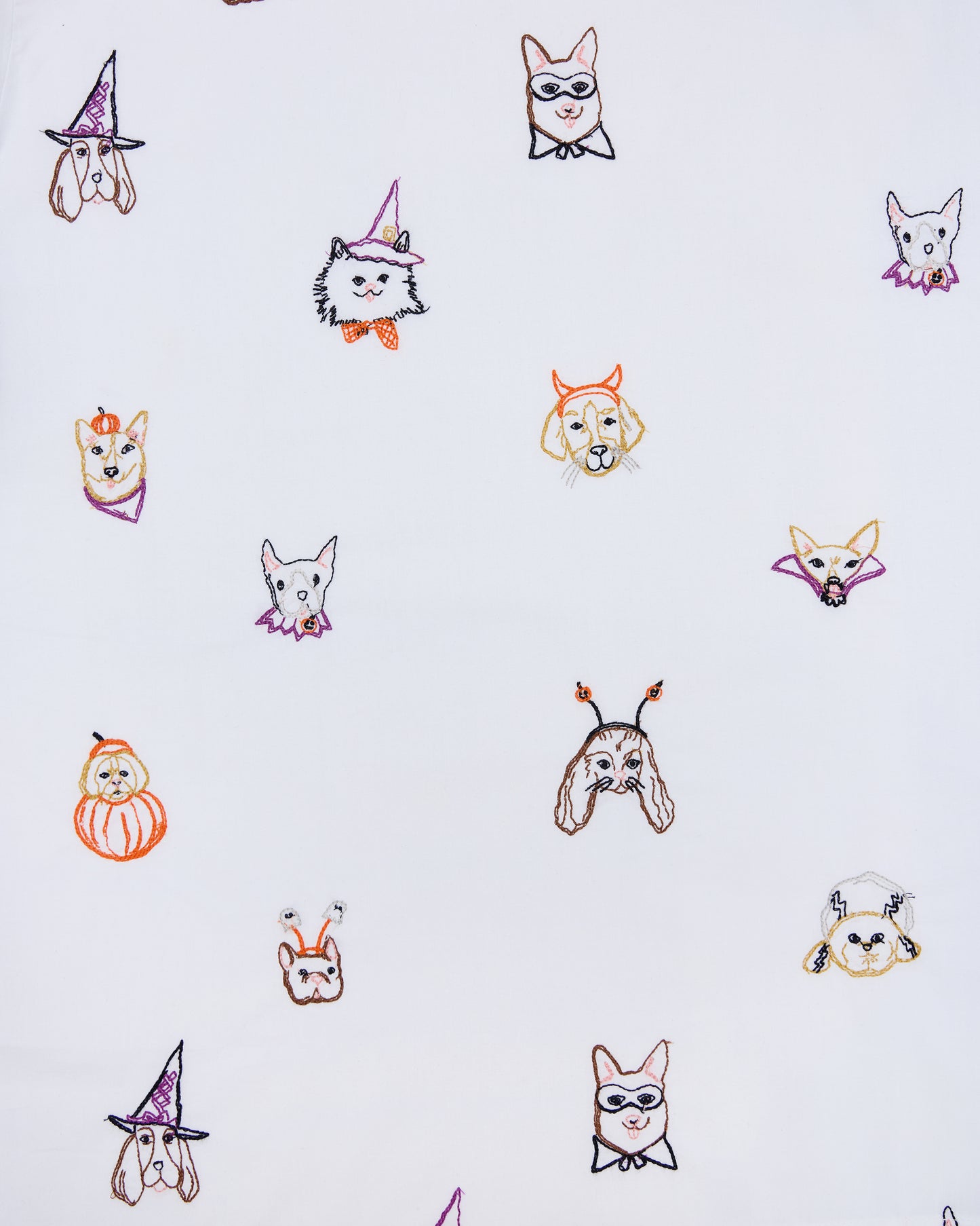 Seamless print of embroidered dog faces in Halloween costumes for the Halloween Hounds petite pajama set.