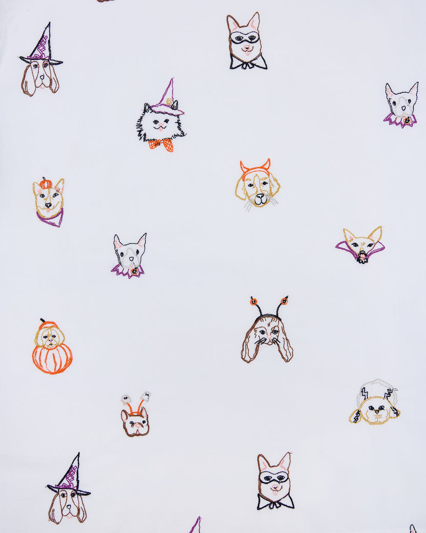 Seamless print of embroidered dog faces in Halloween costumes for the Halloween Hounds petite pajama set.