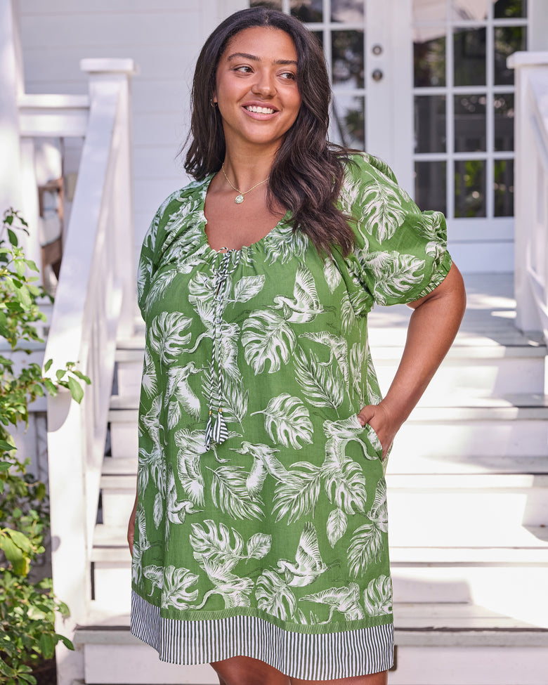 Front view of the olive grove Annie Dress showing its relaxed shape, side pocket, and striped hem