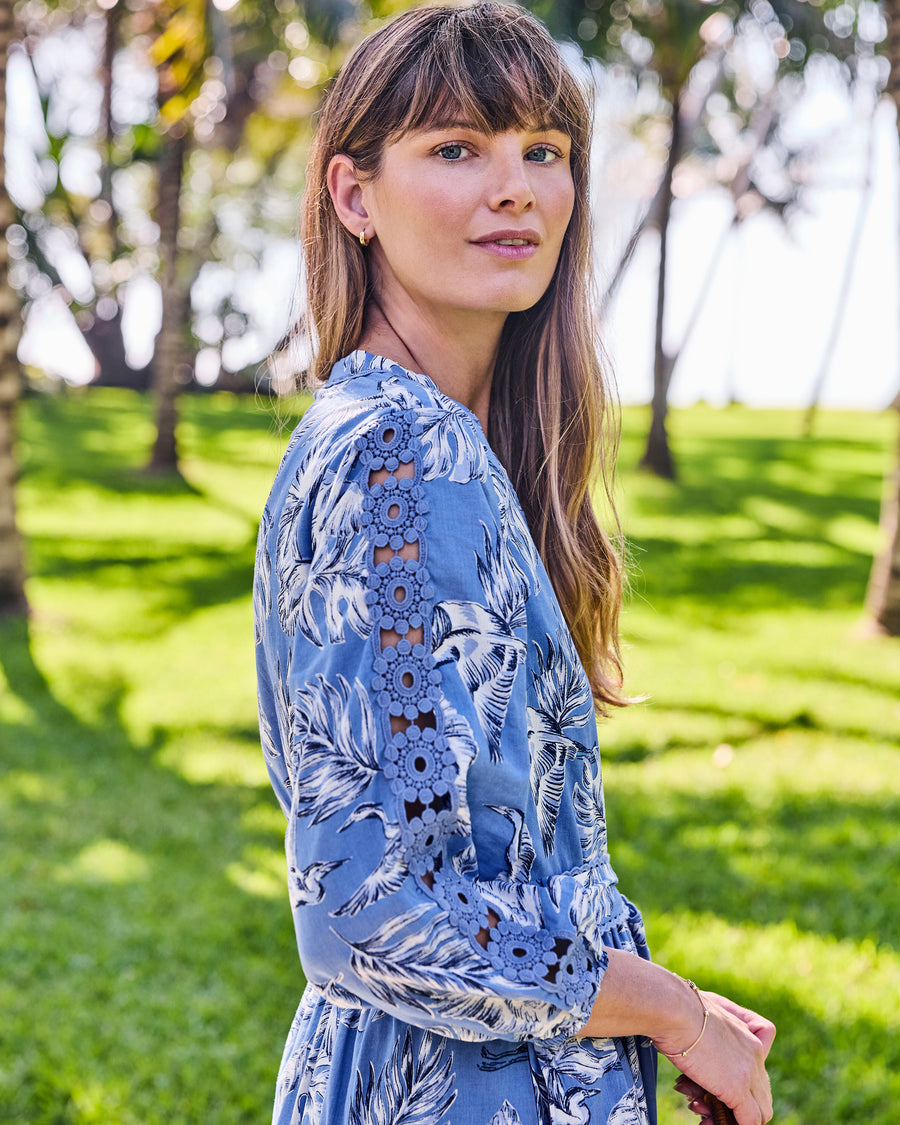Side view of the Monroe dress showing the heron-and-leaf print and floral lace along the three-quarter sleeve