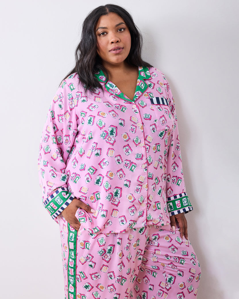 Model wearing the Peony Pink Lucky Tiles pajama set, showing the long-sleeve button-up top and matching pants