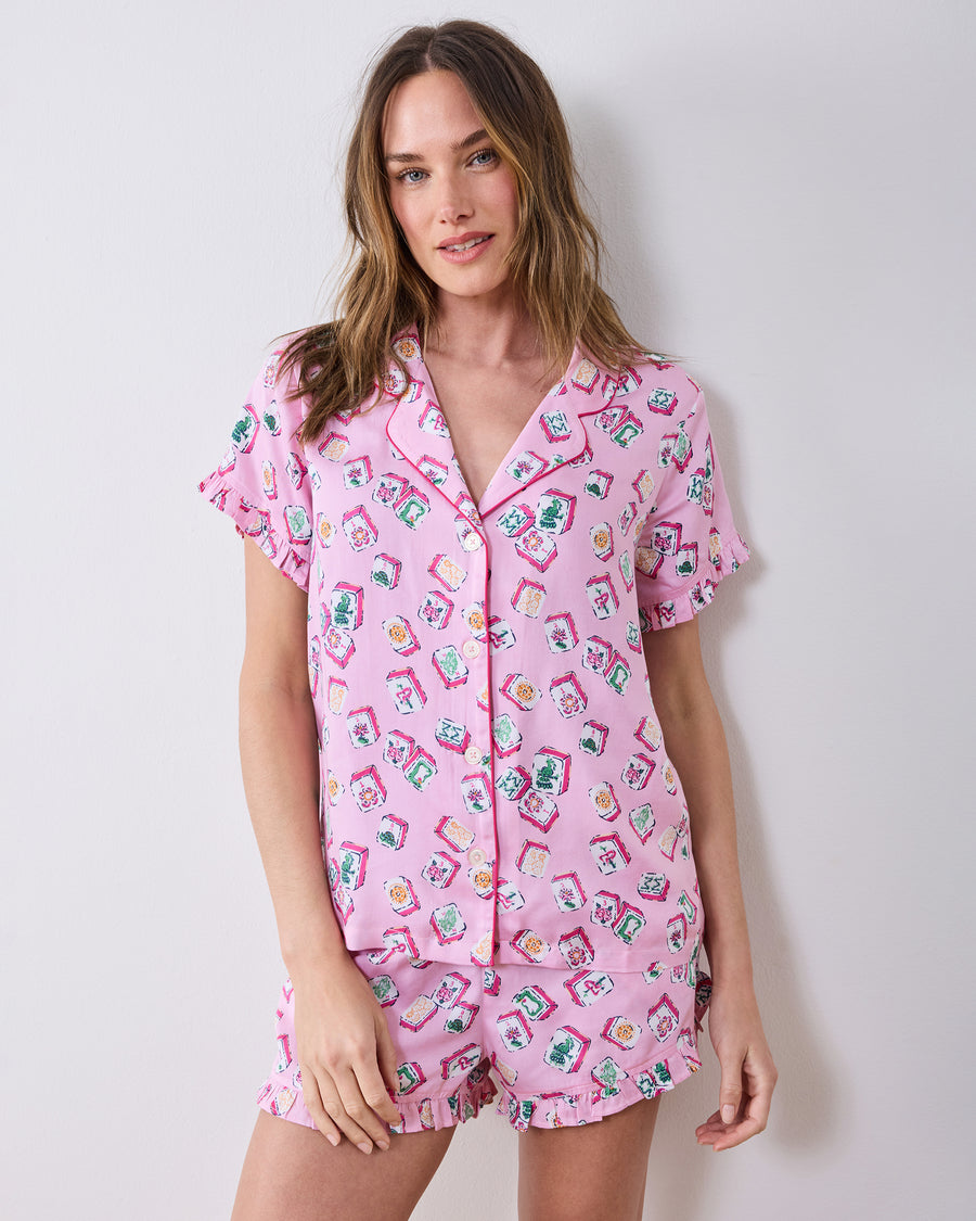 Front view of the peony pink Lucky Tiles pajama set with button-front top and ruffled shorts