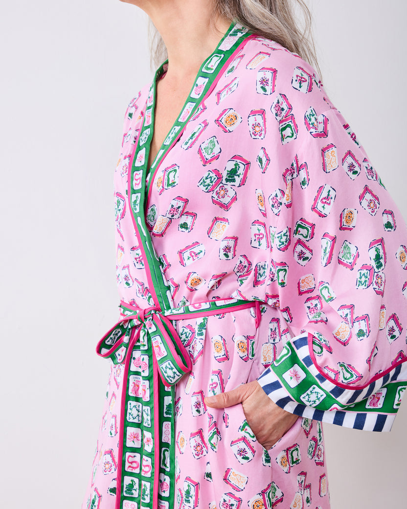 Close side view of the peony pink Lucky Tiles robe showing the tied belt, cuff trim, and pocket