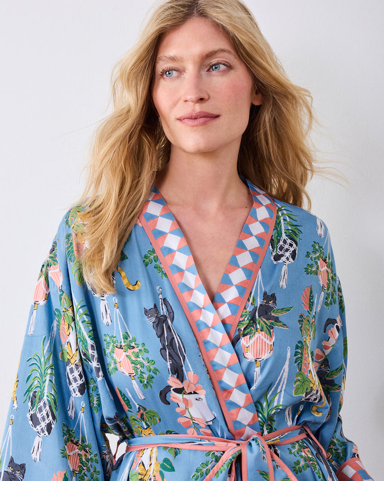 Upper front view of the slate blue robe with geometric lapels and cat-and-houseplant print