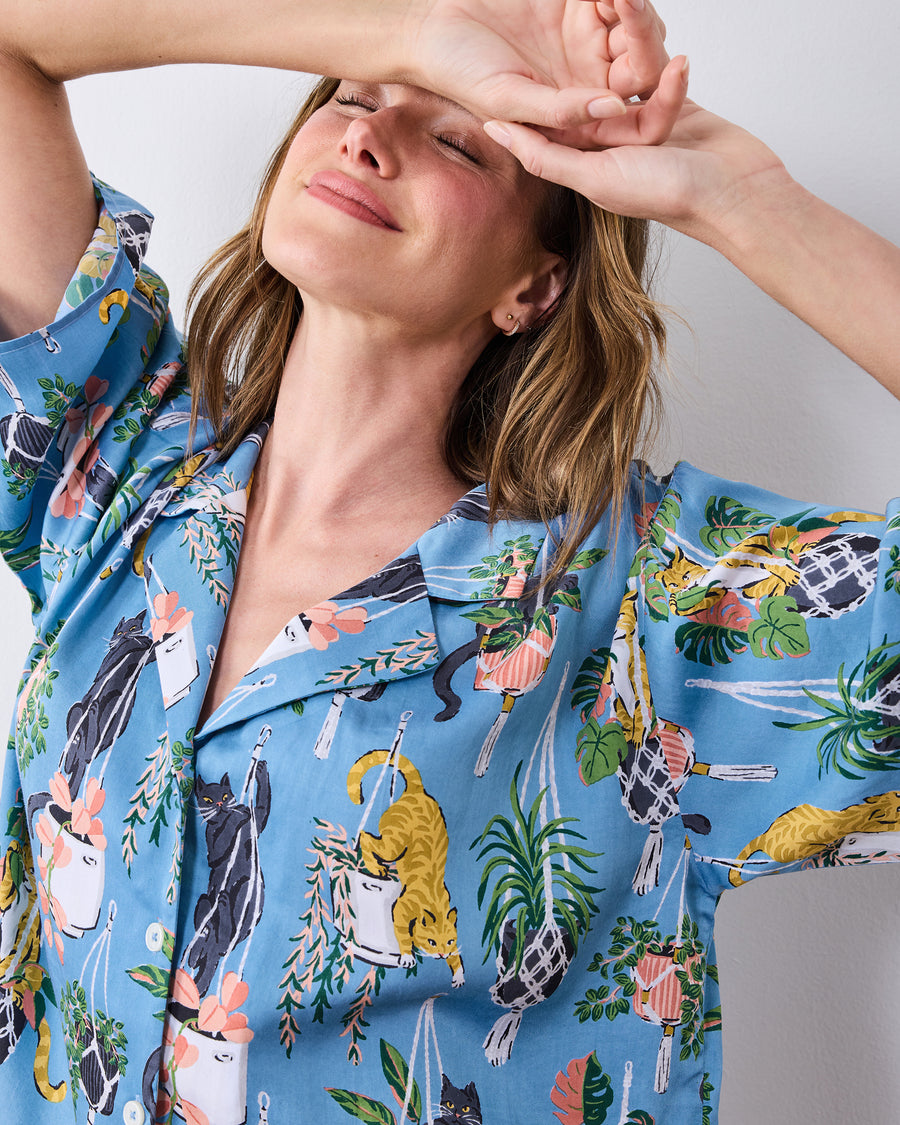 Close view of the short pajama top's collar and cats with hanging plants print