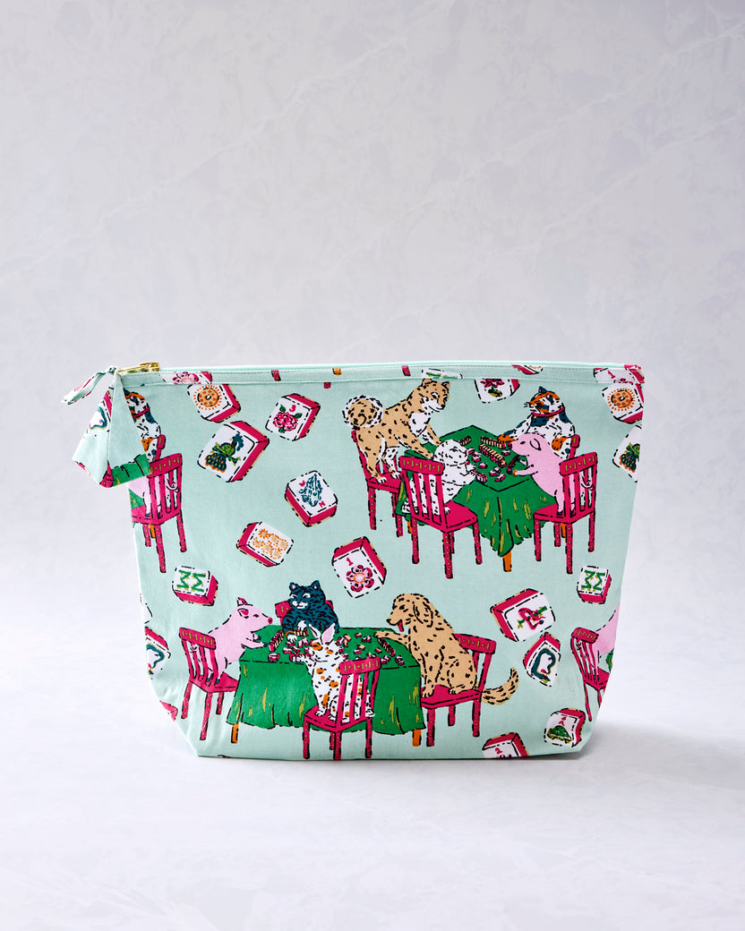 Pale jade essentials pouch with a zipper and a Mah Jongg-themed print featuring animals, game tables, chairs, and tiles.
