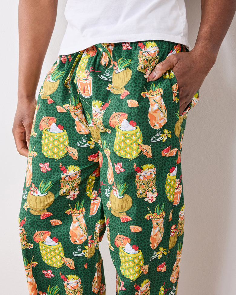 Close-up of green Paradise Punch pajama pants showing the tropical drink print and side pocket