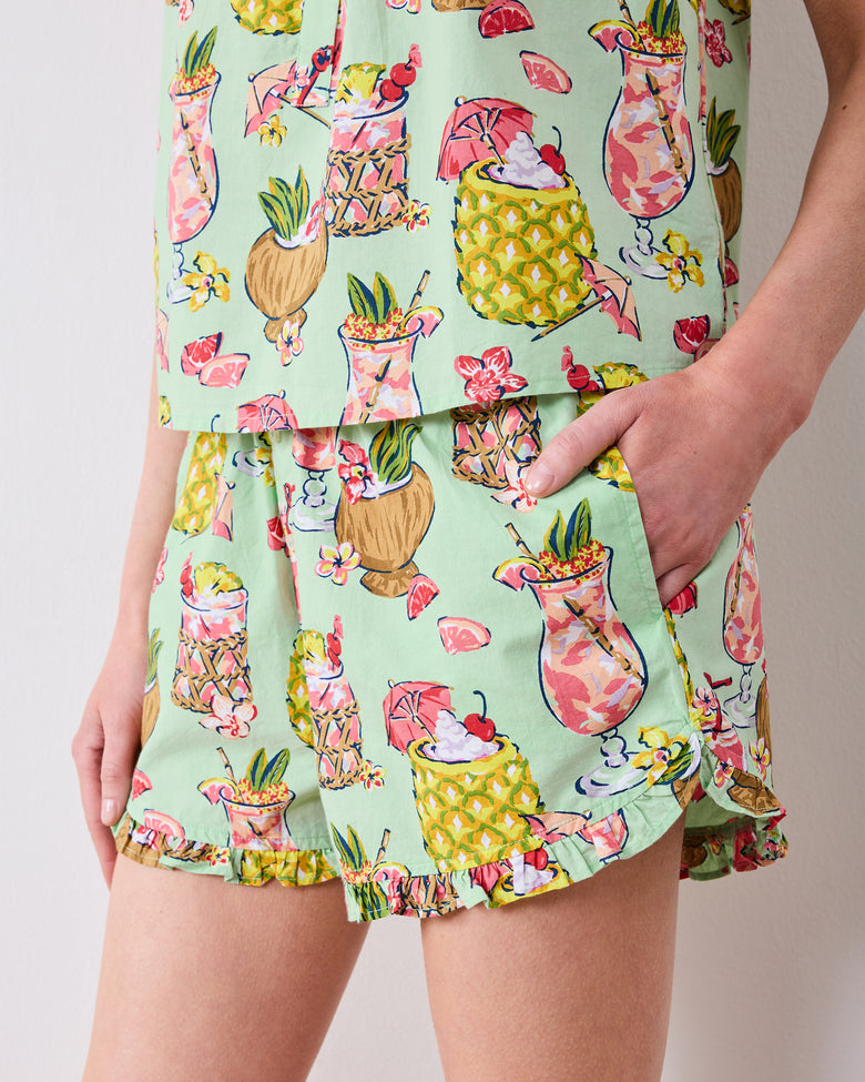 Close-up of the tropical drink print, ruffled shorts hem, and pocket on the Mojito short set
