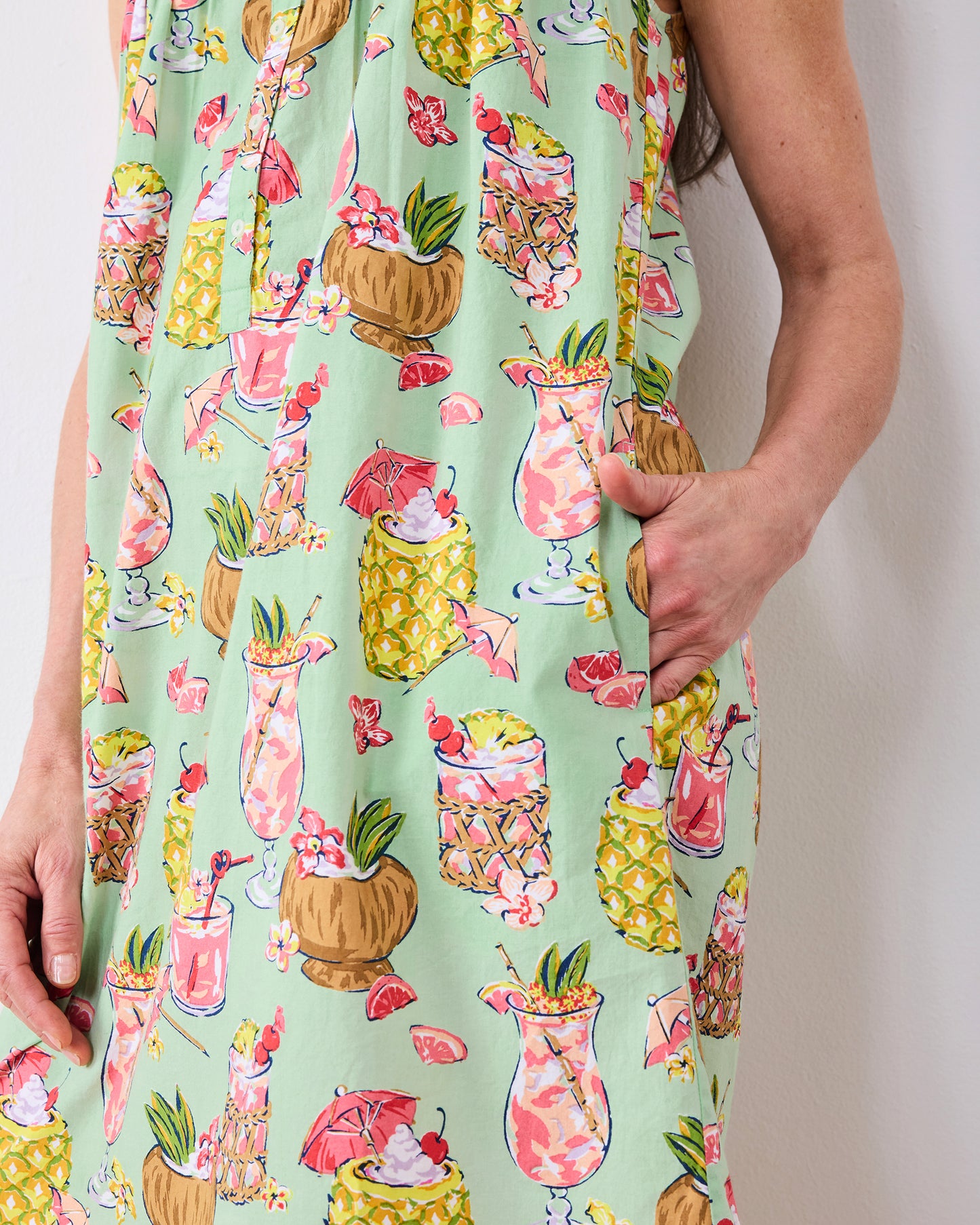 Close-up of the mint-green Paradise Punch nightgown showing its tropical drink print and side pocket