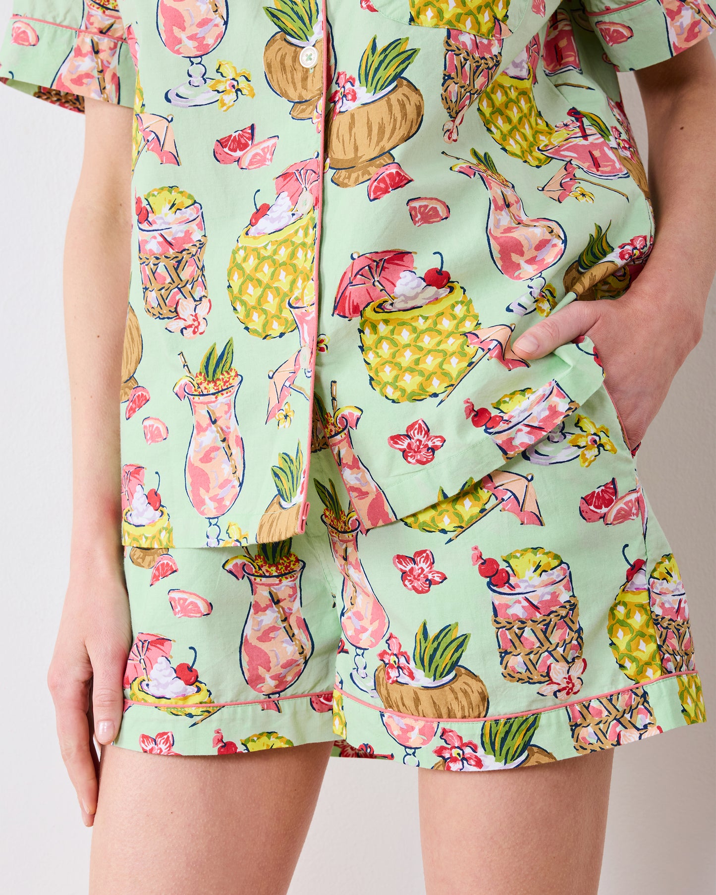 Close-up of the Mojito pajama set showing the shirt hem, shorts pocket, and piped cuffs