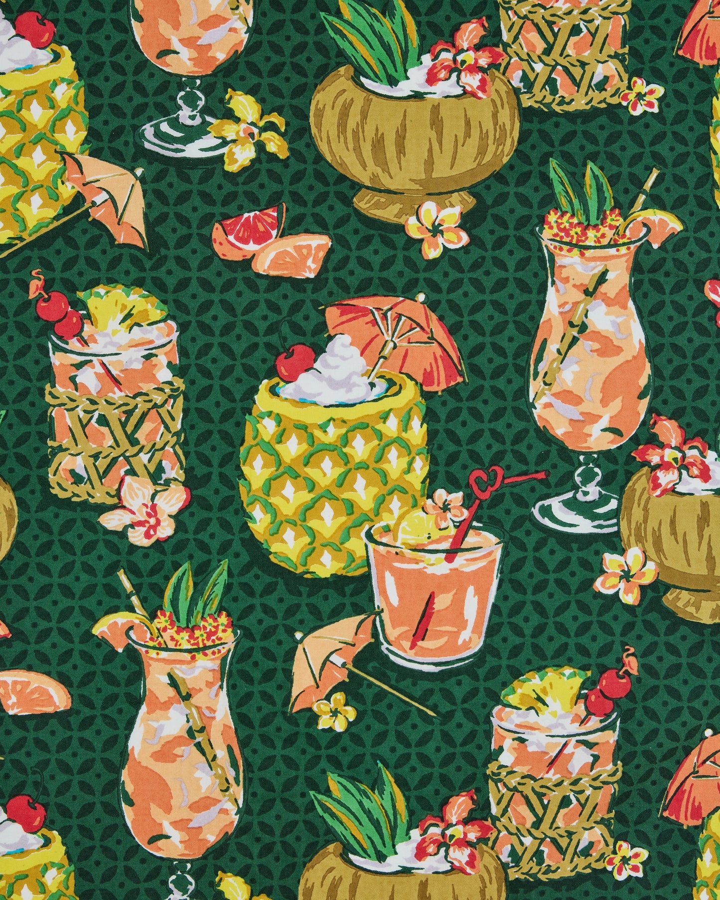 Close view of the green print featuring tropical drinks in pineapples, coconuts, and glasses with fruit and flowers