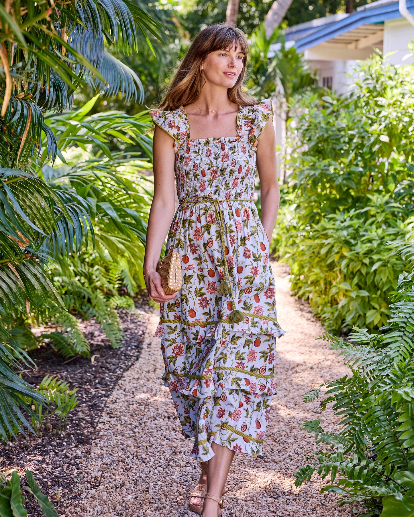 Full-length front view of the Billie Dress in motion, showing its ruffled straps, tie belt, and tiered midi skirt