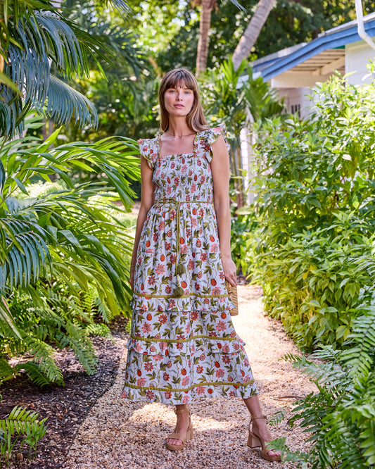 Full-length front view of the Billie Dress with a smocked bodice, tie belt, and tiered midi skirt