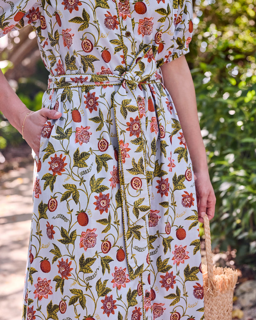 Close view of the Passion Vine Presley Dress showing the self-tie belt, button front, pocket, and floral fruit print