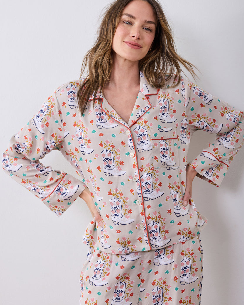 Front close-up of the long-sleeve pajama top with notched collar, buttons, chest pocket, and red piping.