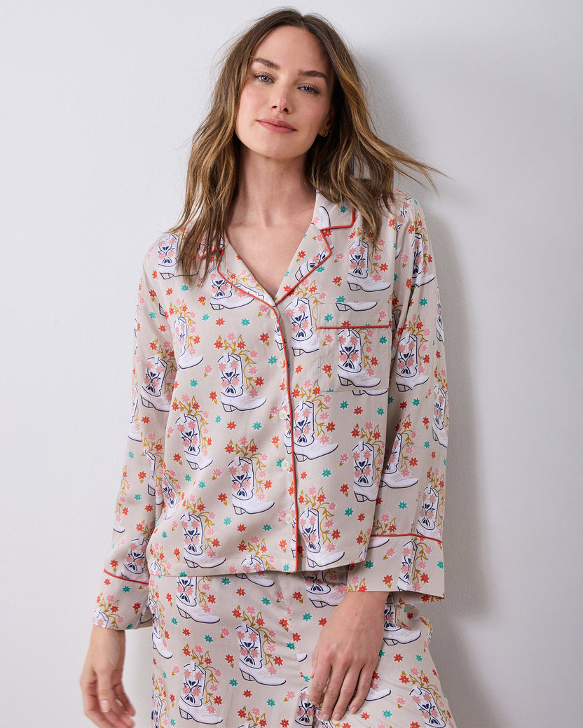 Model wearing the Desert Sand Rhinestone Cowgirl petite pajama set with a Western boot print and contrasting piping and side panels.