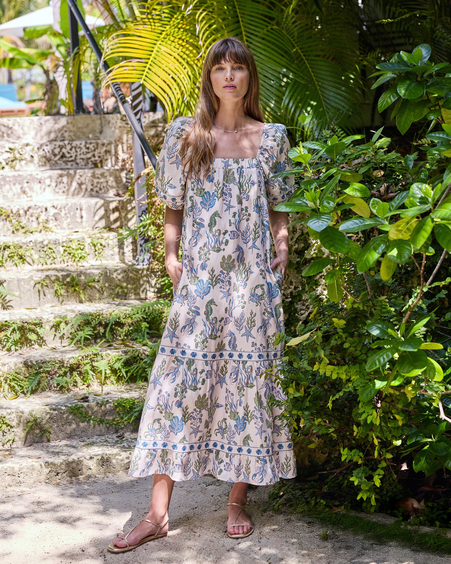 Full-length front view of the sand Collins Dress with square neckline, puff sleeves, underwater print, and tiered hem