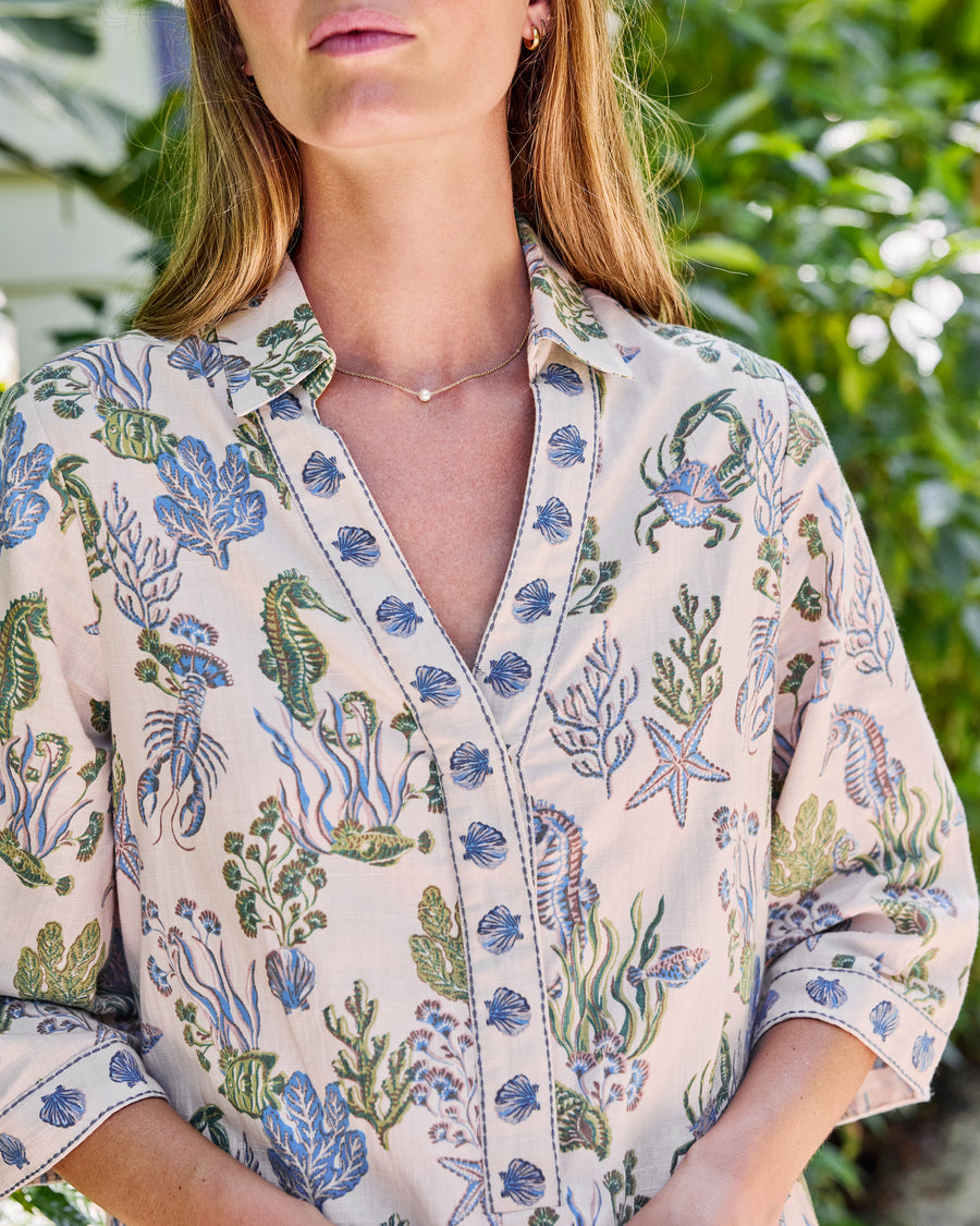 Close-up of the sand Goa dress collar and blue-green sea creature print