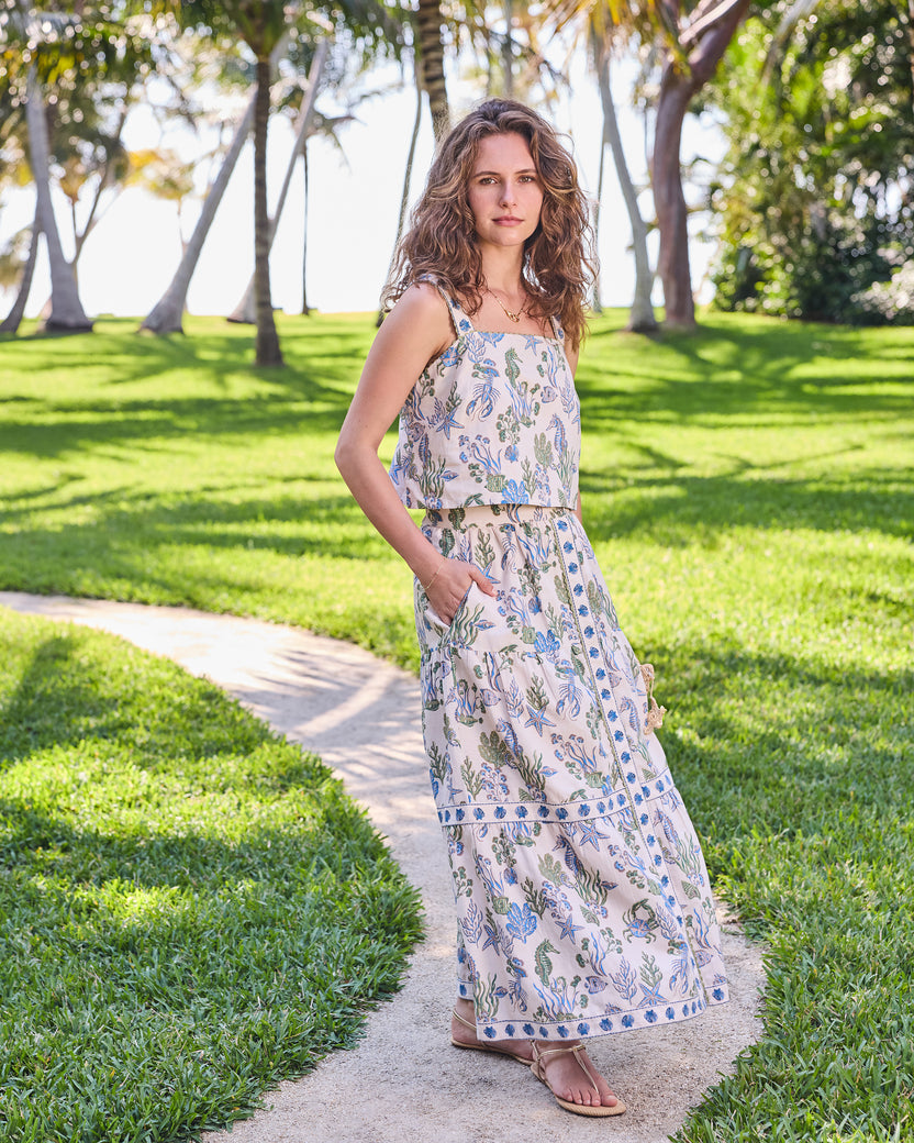 Full-length front view of the sand Tessa top and skirt set with an underwater print and skirt pockets