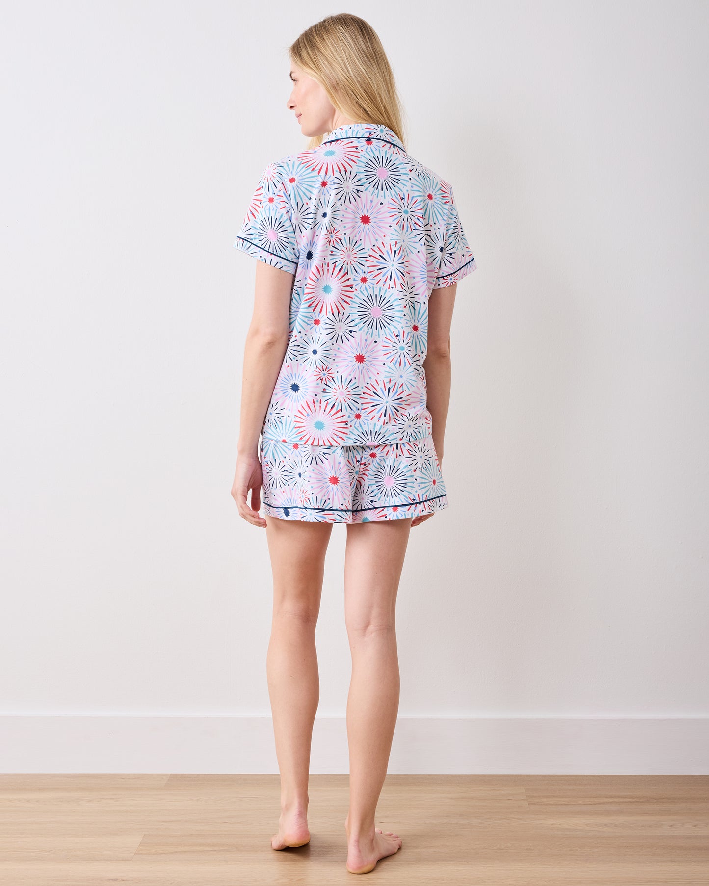 Full-length back view of the fireworks-print short pajama set