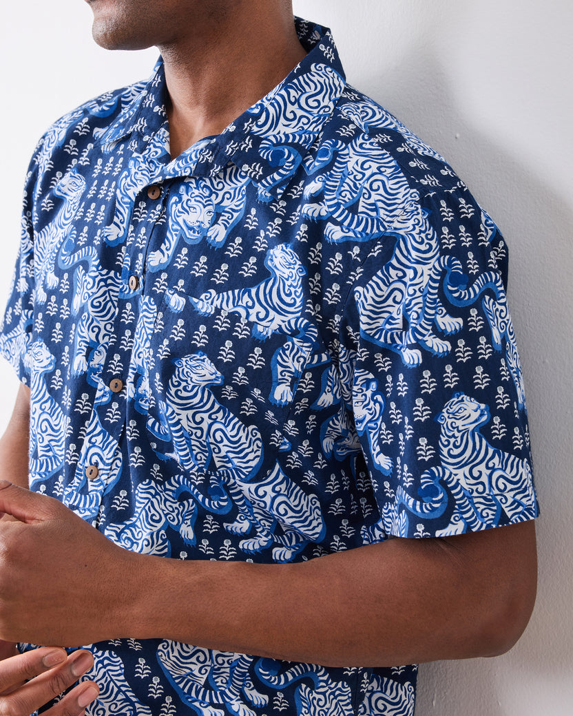 Close-up of the indigo tiger-print shirt's collar, buttons, chest pocket, and short sleeve