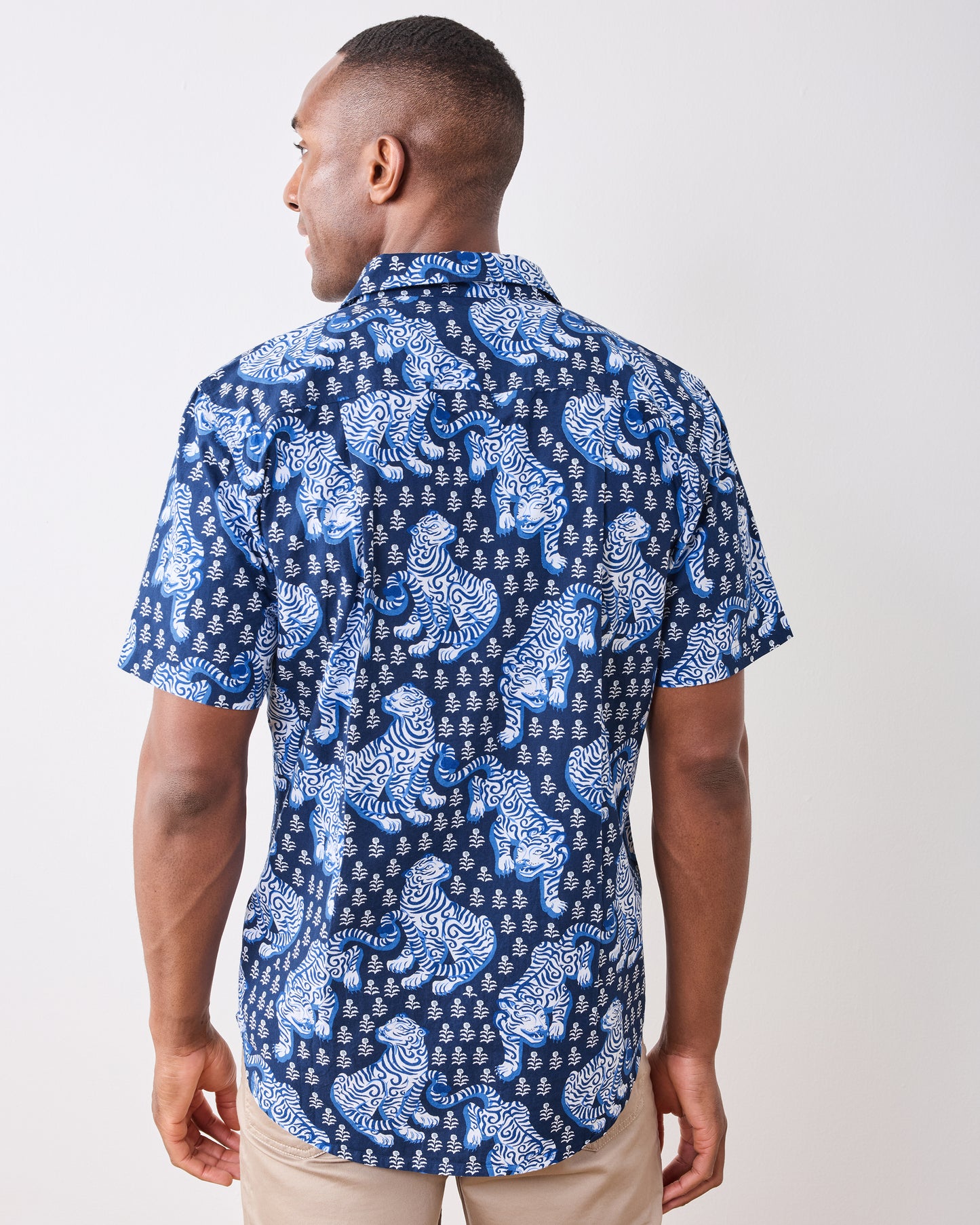 Back view of the indigo short-sleeve shirt with an allover white and blue tiger print