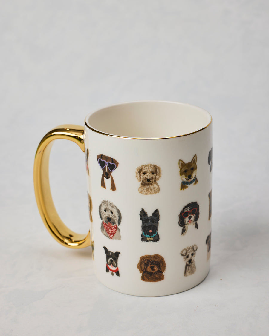 Dog Days porcelain mug shown from an angled view with a gold handle and rows of illustrated dogs wearing accessories.