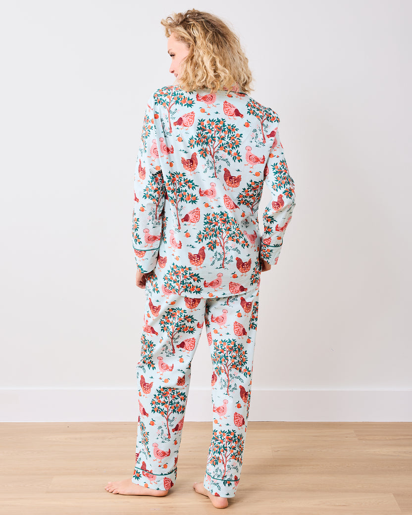 Back view of the long pajama set with a chicken and fruit-tree print on a light blue background