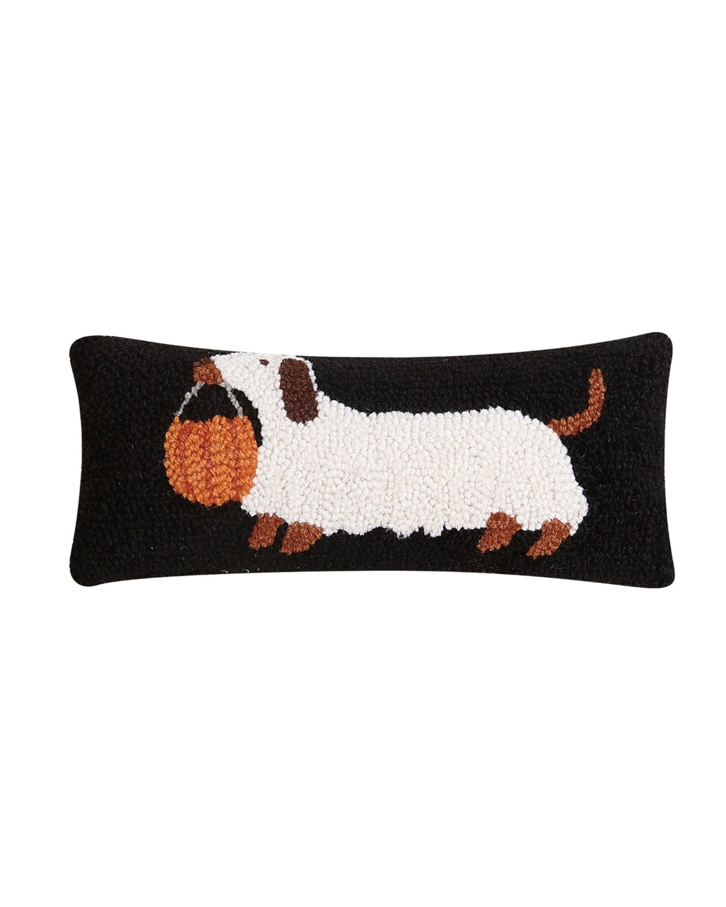 Black rectangular hooked pillow featuring a white dachshund carrying an orange pumpkin bucket.