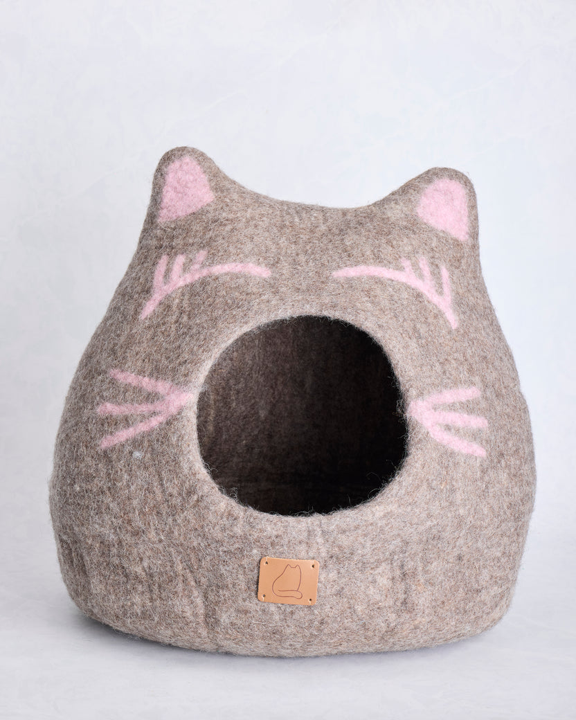 Alternate front view of the taupe wool cat cave bed with pink facial details and a round opening