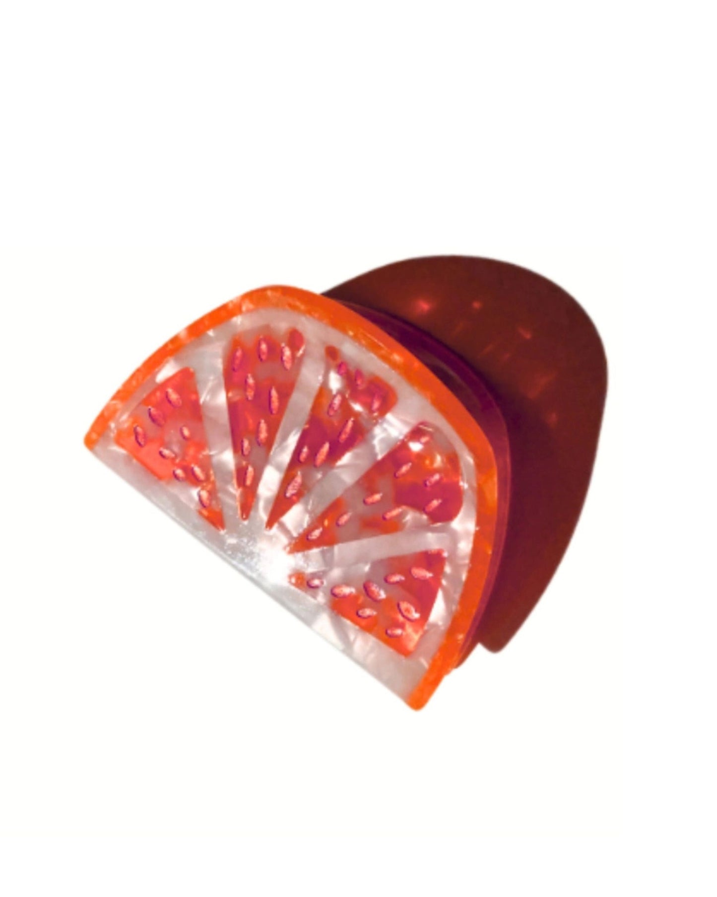 Grapefruit-slice claw hair clip shown at an angle on a white background.