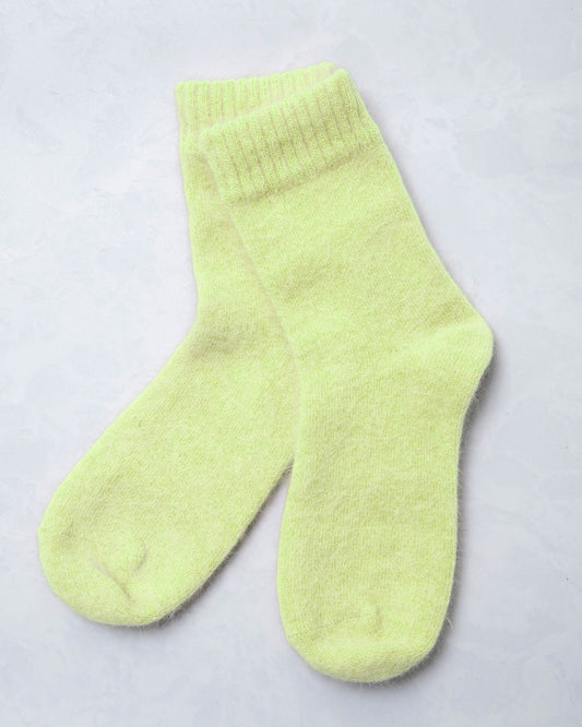 Pair of lime green cozy socks shown against a light background.