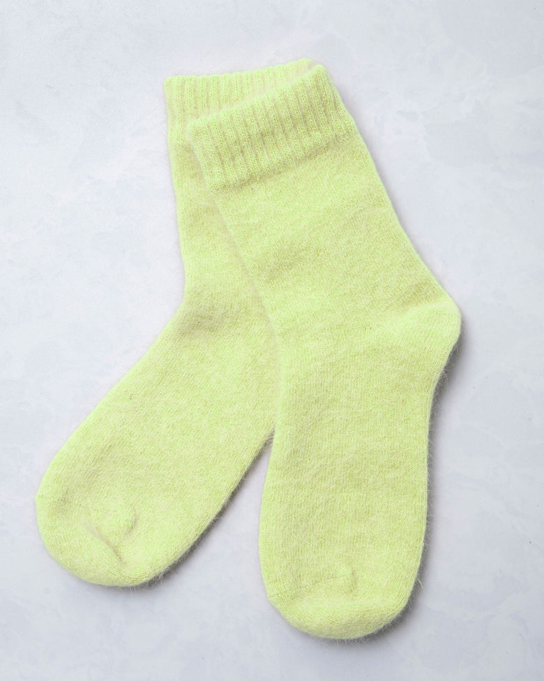 Pair of lime green cozy socks shown against a light background.