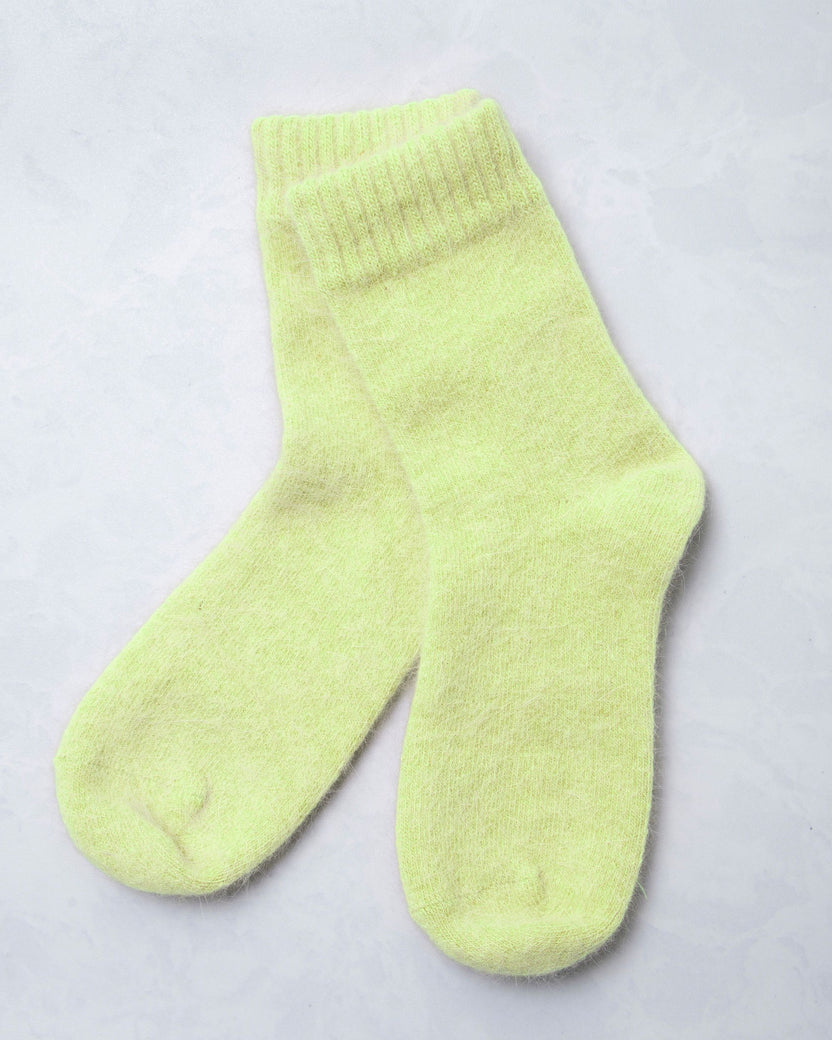 Pair of lime green cozy socks shown against a light background.