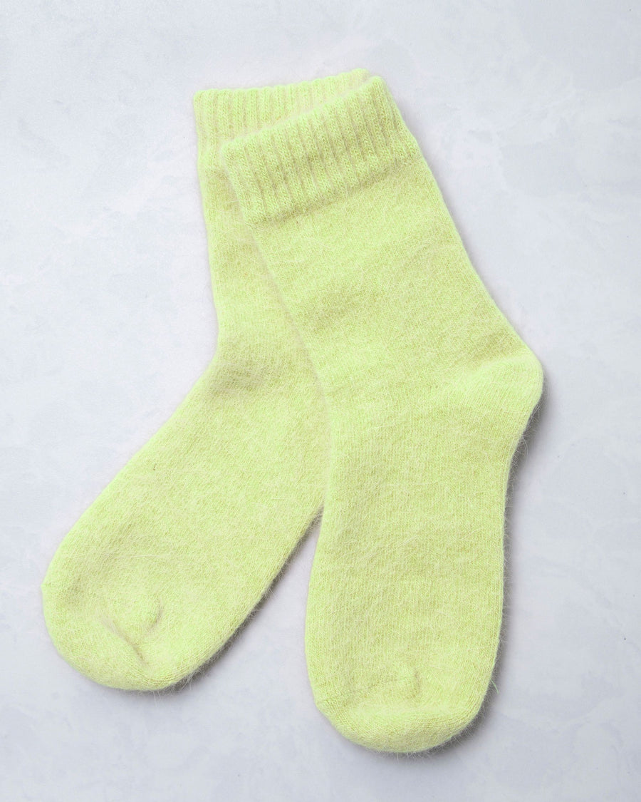 Pair of lime green cozy socks shown against a light background.
