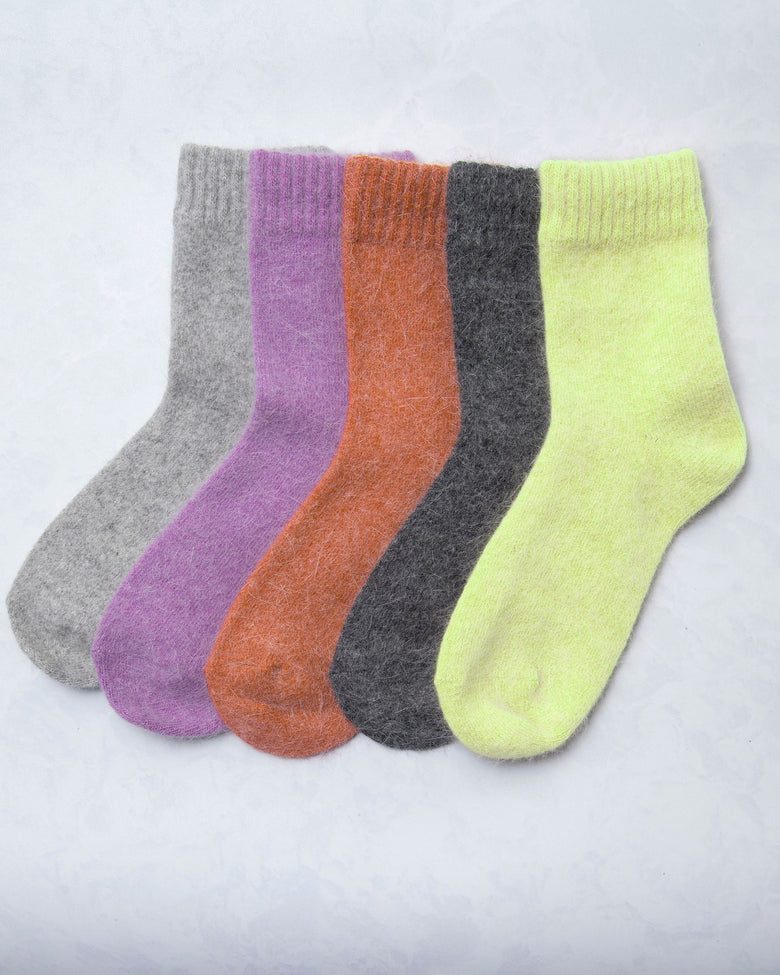 Five cozy socks displayed side by side in gray, purple, orange, charcoal, and lime green.