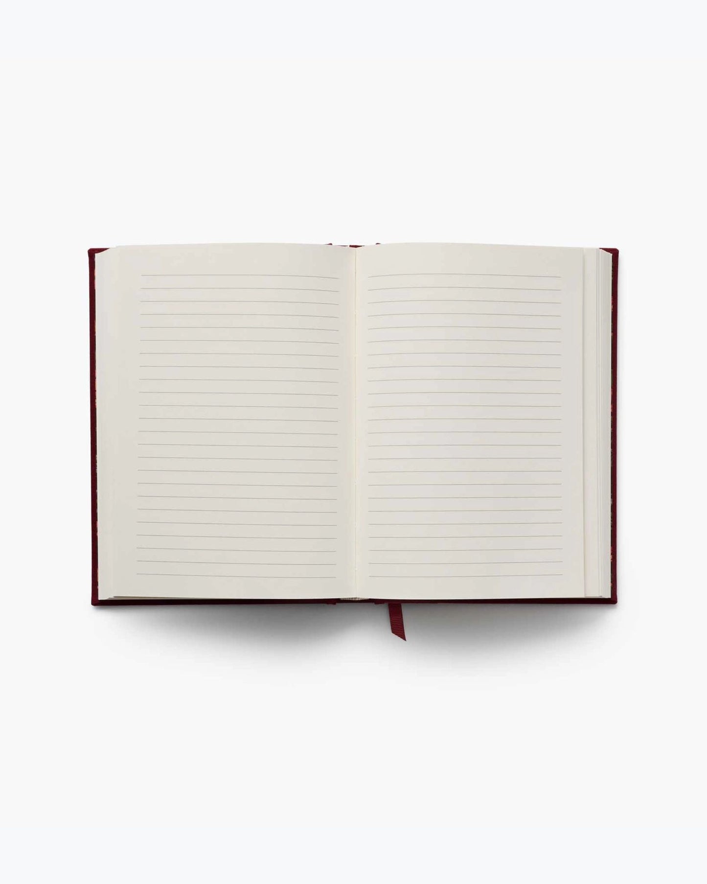 Gracie journal opened to two blank lined pages with a red ribbon bookmark.