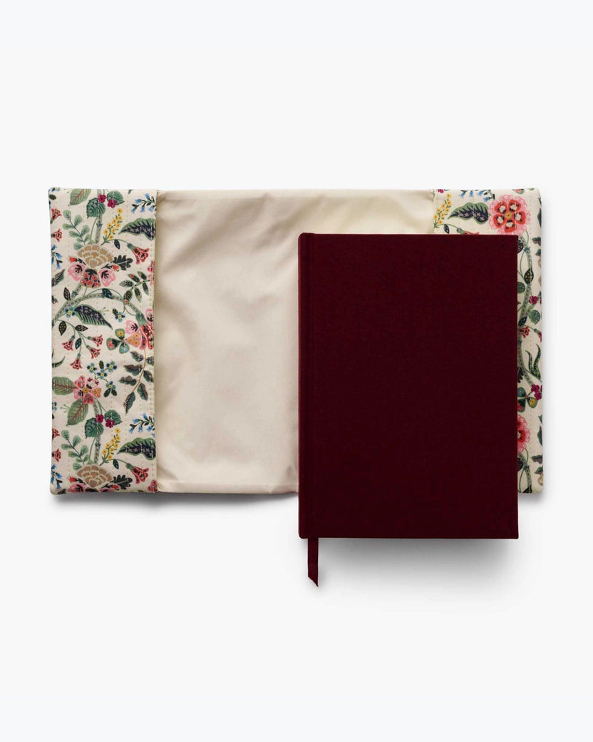 Gracie journal with its burgundy cover resting on a cream floral quilted cover, showing the removable cover and journal interior.