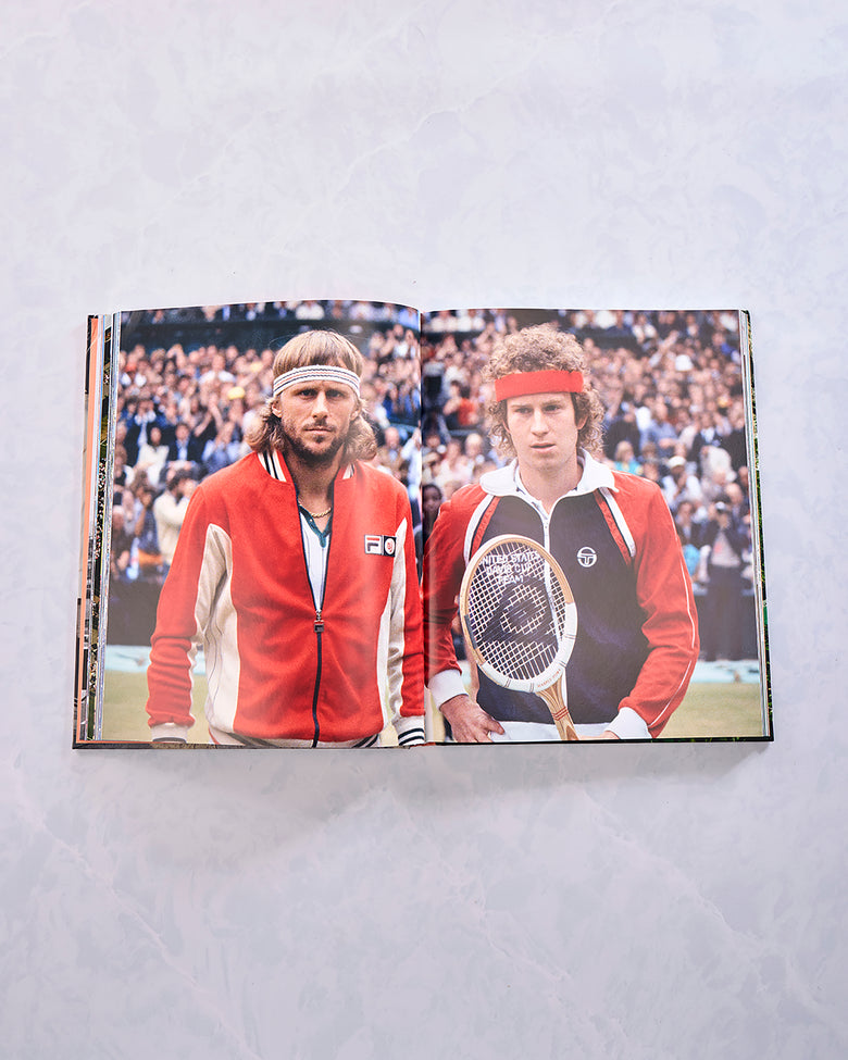Open book showing a historical tennis photograph of two players holding tennis rackets.