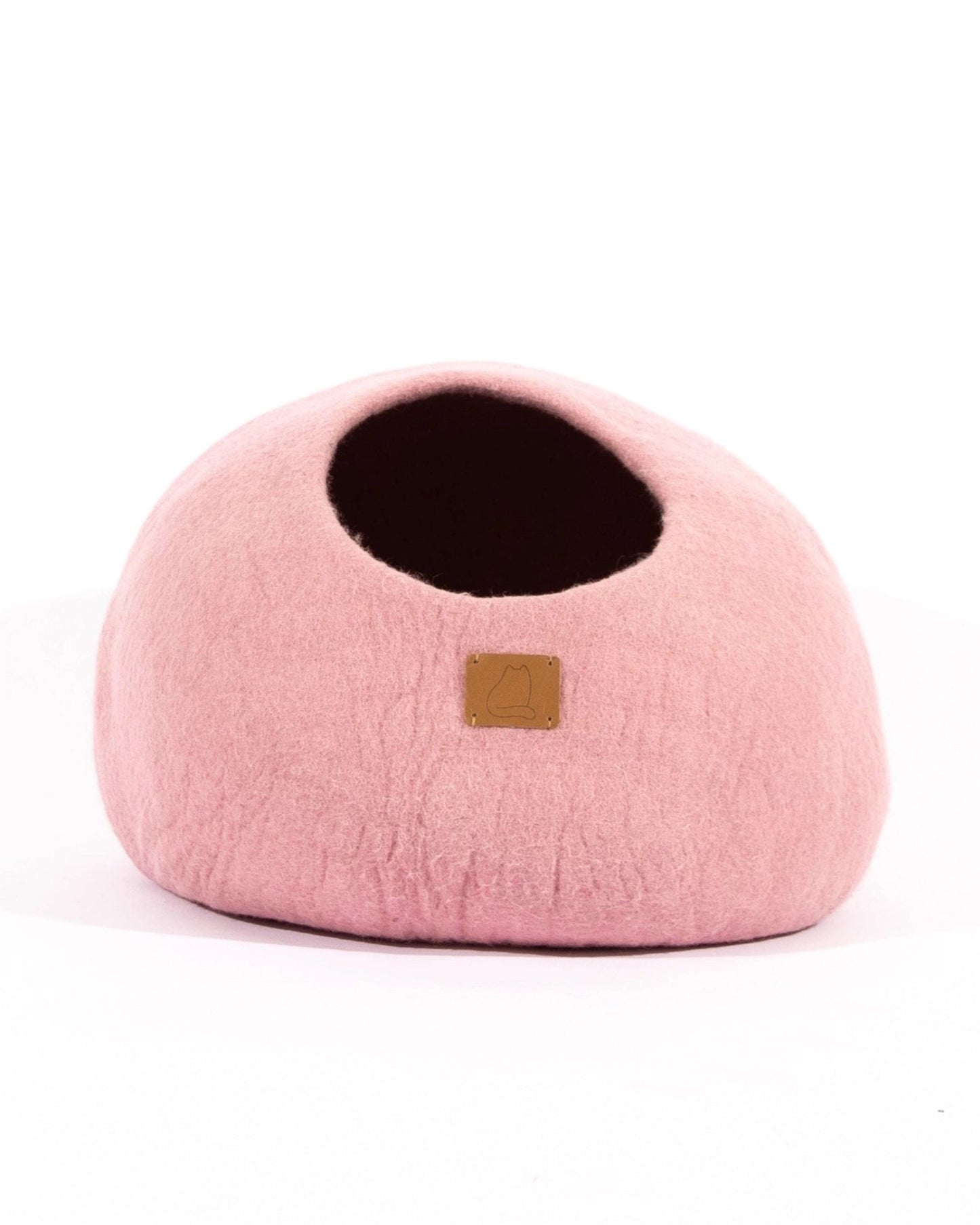 Pink cave-style cat bed shown from the rear with its opening visible.