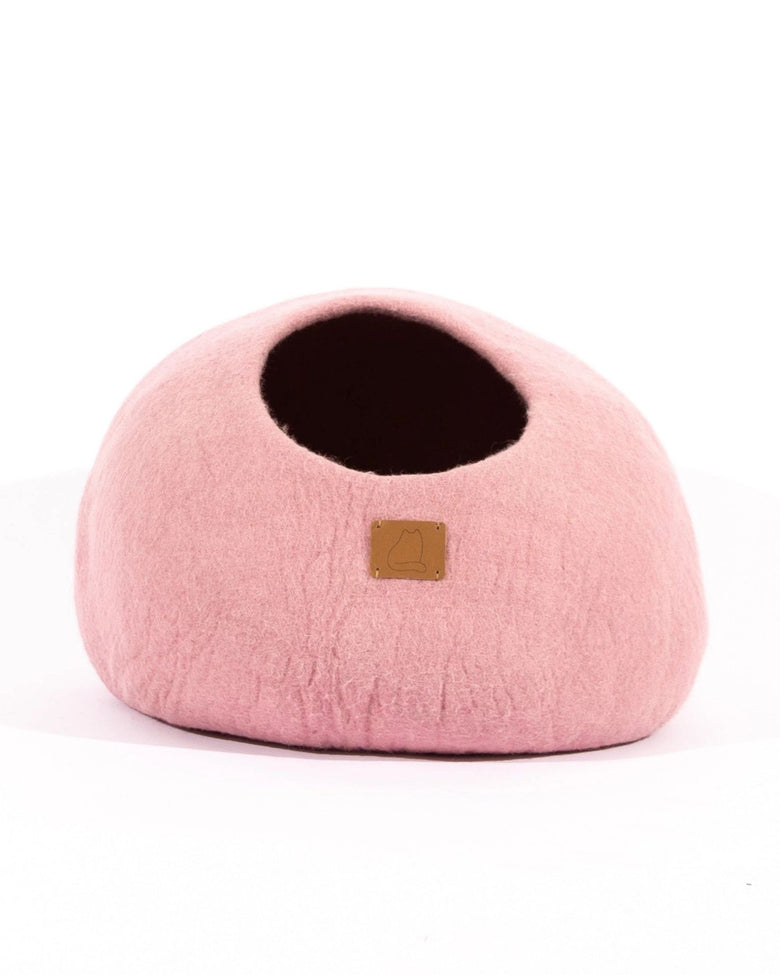 Pink cave-style cat bed shown from the rear with its opening visible.