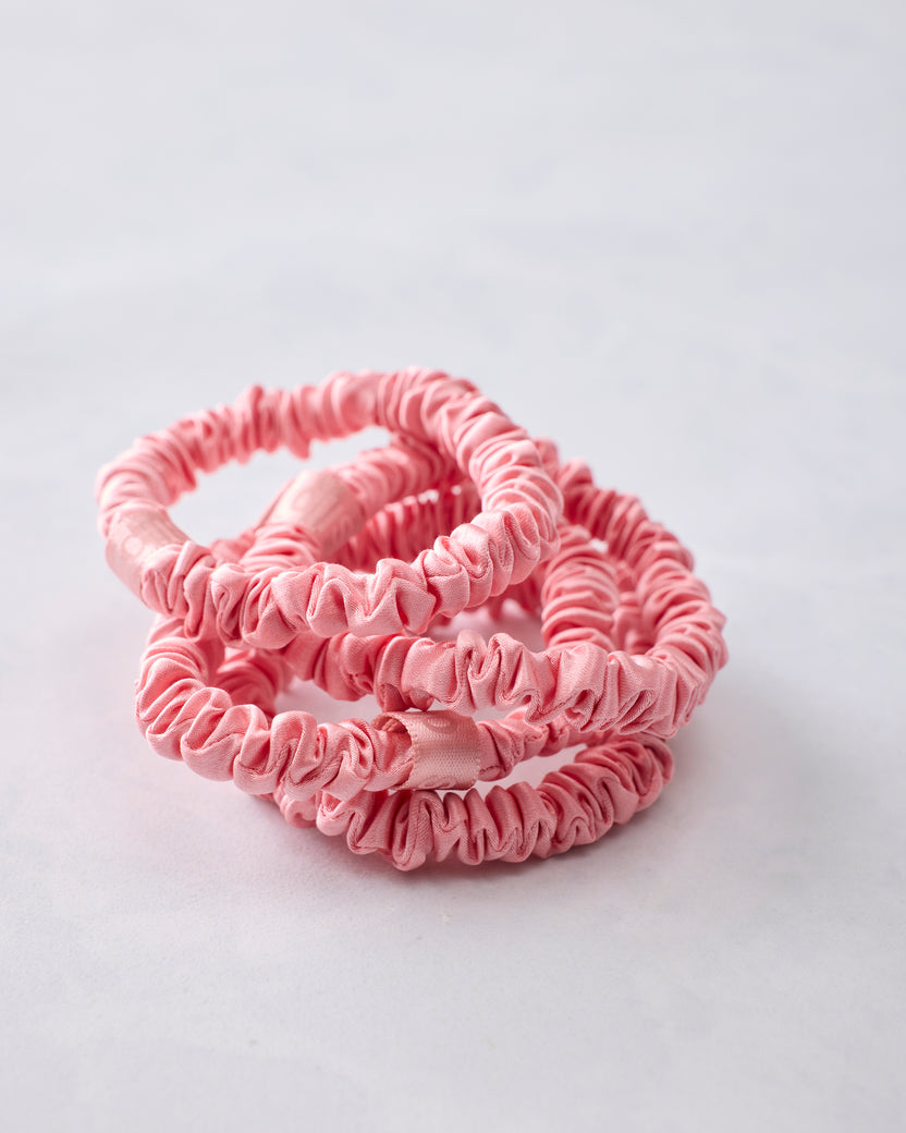 Four rose skinny scrunchies removed from the packaging and overlapping