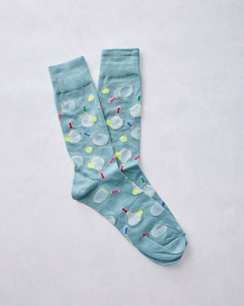 Overlapping blue crew socks with tennis racket and ball print
