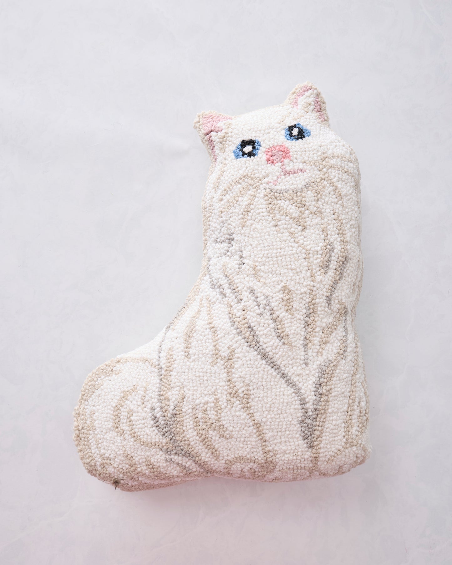 White cat-shaped hooked pillow with gray stripes and embroidered facial features