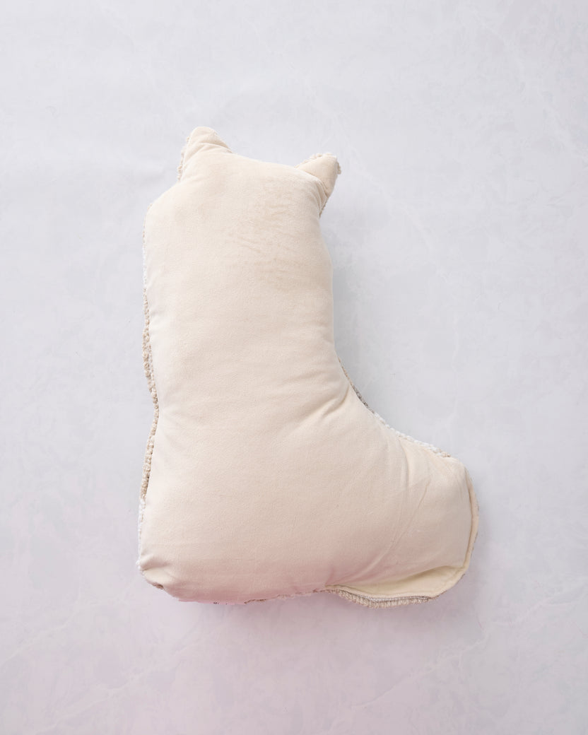 Back view of the white cat-shaped pillow with a plain cream backing