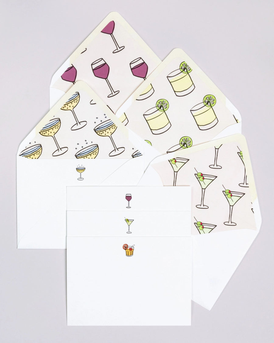 Happy Hour notecard set with white envelopes and cards featuring repeated illustrations of cocktails, wine glasses, and lime drinks.